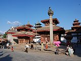 
Running northeast is a second part of Kathmandu Durbar Square, which contains the entrance to the Hanuman Dhoka and an assortment of temples. Pigeons fly around the three-tiered, two-storied Jagannath Temple, built in the 16C. Exquisite wood-carvings embellish the doors, windows and roof struts, depicting Hindu gods. Erected in 1670, King Pratapa Malla's column stands to the left of Jagannath temple. The king sits on a lion throne atop the lotus-shaped capital, his two wives one on either side. The King's five sons also appear, one at each corner and the fifth, the youngest son, in front. On the right is the Hanuman statue at the entrance to the Hanuman Dhoka palace.
